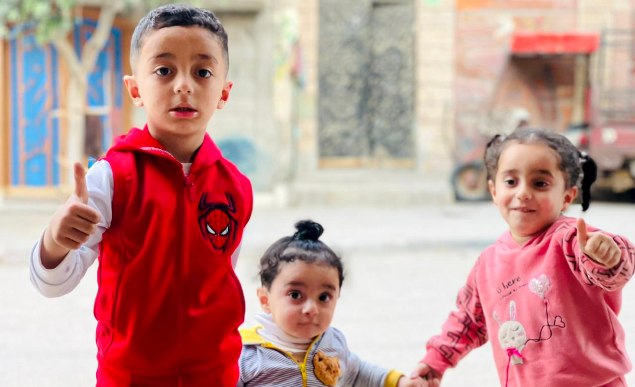 Three children holding hands, symbolizing unity and peace before the onset of war