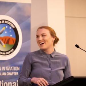 A woman presenting information to aspiring female aviators