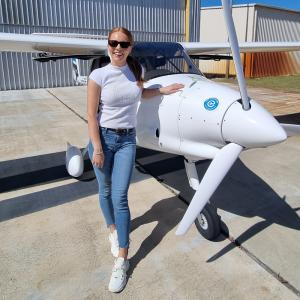 Woman in front of an electric plane